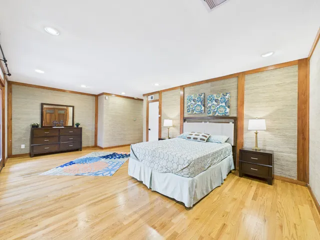 a spacious bedroom with a large bed and a large window