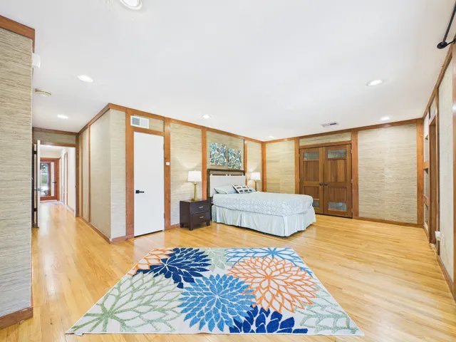 a spacious bedroom with a bed and a large window