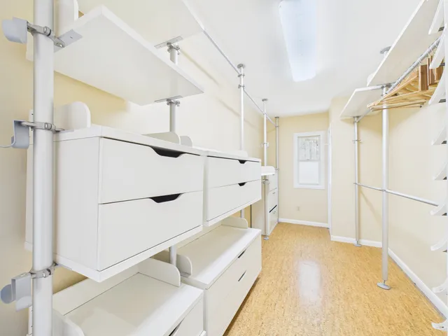 a view of hallway with stairs and a chandelier