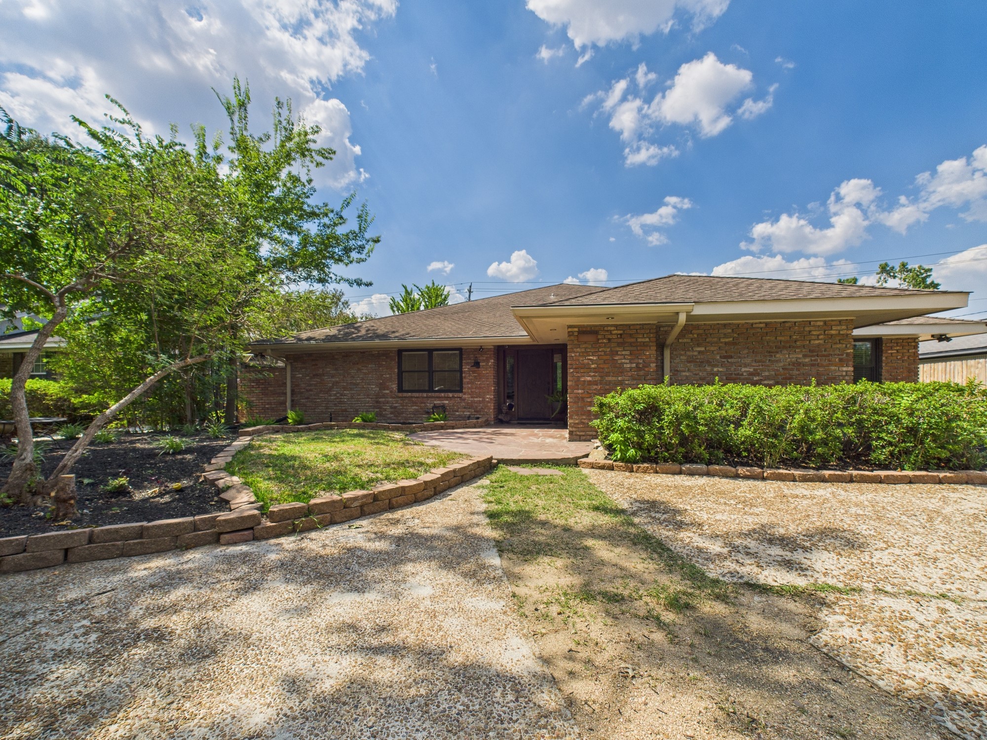 2432 Chimney Rock Road Houston, TX 77057 - Photo 40 of 43 a front view of a house with a yard and garage