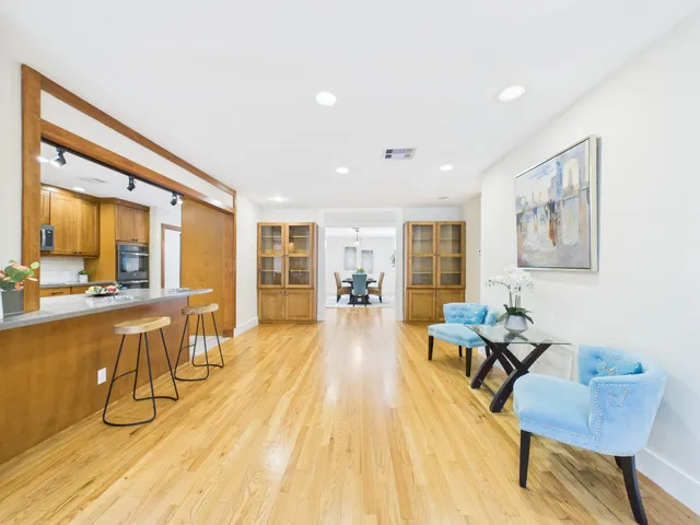 a view of a dining room with furniture and wooden floor