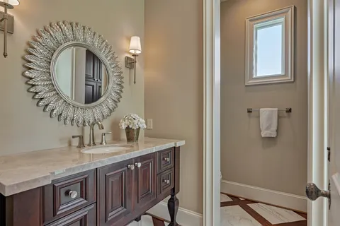 a bathroom with a toilet a sink and a mirror