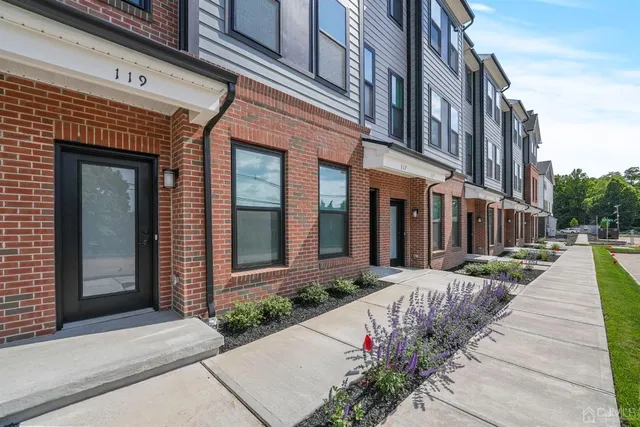 a view of a brick building with a yard