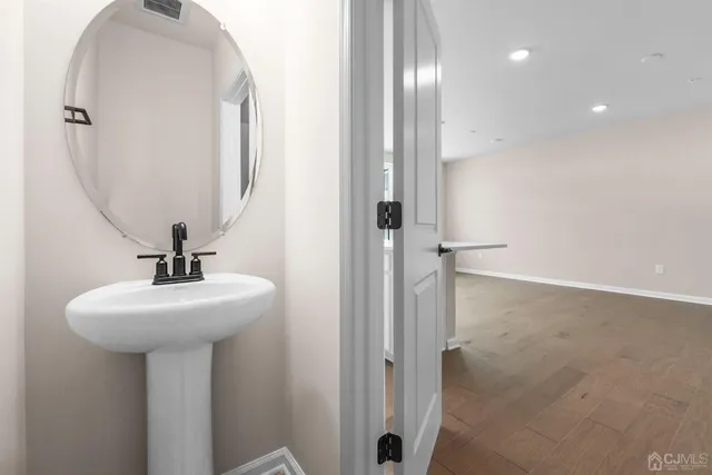 a bathroom with a sink a mirror and shower