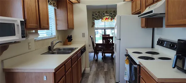 a kitchen that has a sink a stove and a table