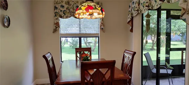 a view of a dining room with furniture and a window