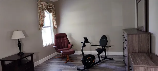 a view of a workspace with furniture and a window