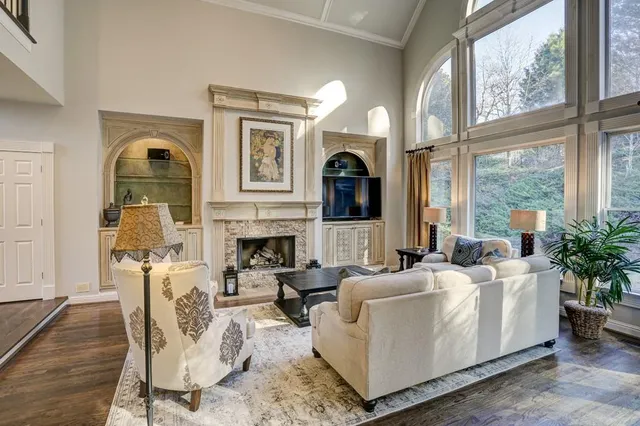 a living room with furniture fireplace and flat screen tv