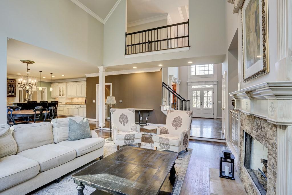 5940 Whitestone Lane Suwanee, GA 30024 - Photo 12 of 63 a living room with furniture a fireplace and a flat screen tv