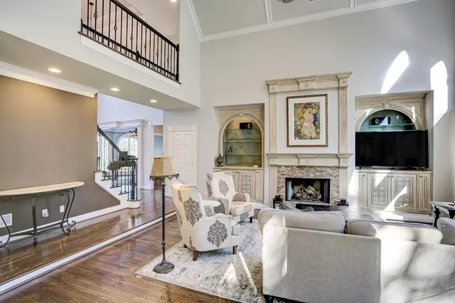 a living room with furniture a flat screen tv and a fireplace