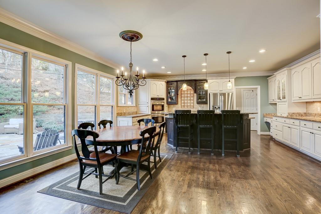 5940 Whitestone Lane Suwanee, GA 30024 - Photo 14 of 63 a view of a dining room with furniture window and wooden floor