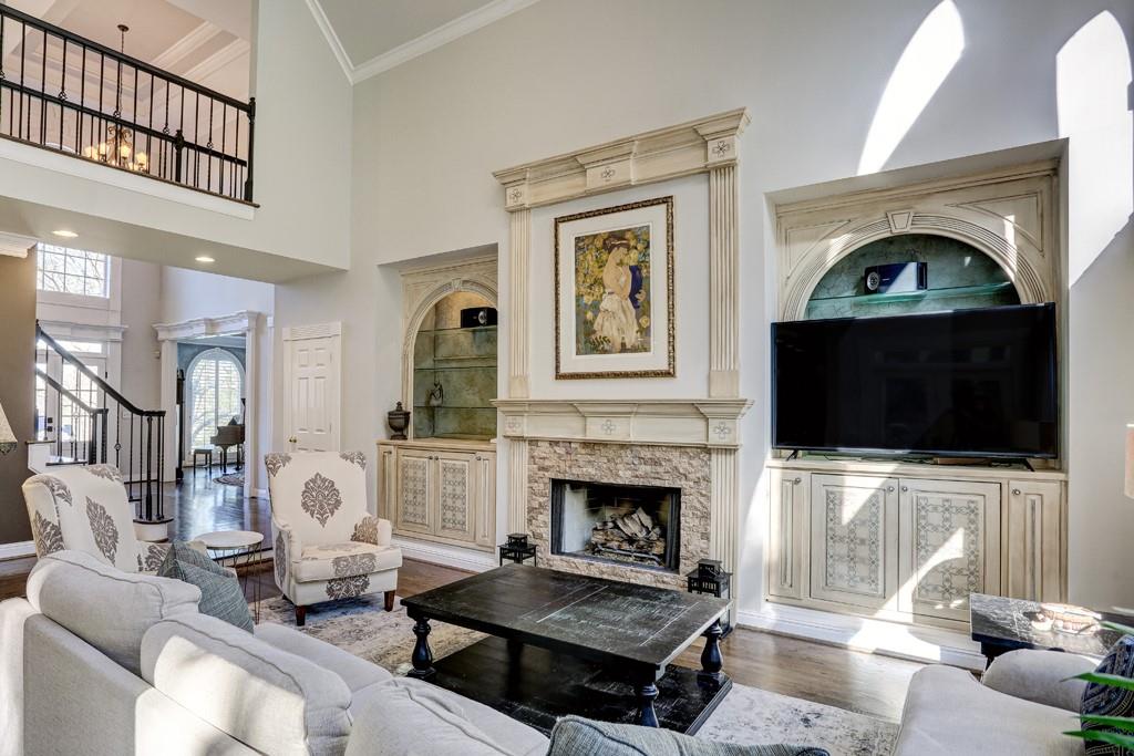 5940 Whitestone Lane Suwanee, GA 30024 - Photo 15 of 63 a living room with furniture a flat screen tv and a fireplace