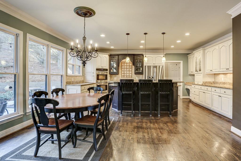 5940 Whitestone Lane Suwanee, GA 30024 - Photo 16 of 63 a view of a dining room with furniture and chandelier