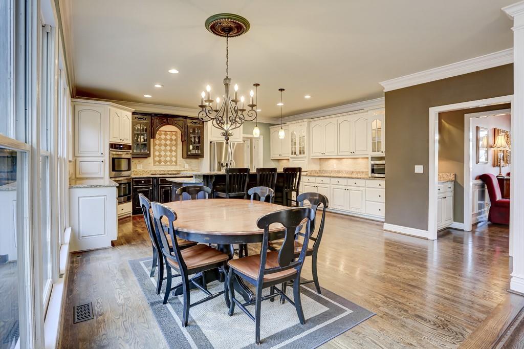 5940 Whitestone Lane Suwanee, GA 30024 - Photo 20 of 63 a view of a dining room and livingroom with furniture wooden floor a chandelier