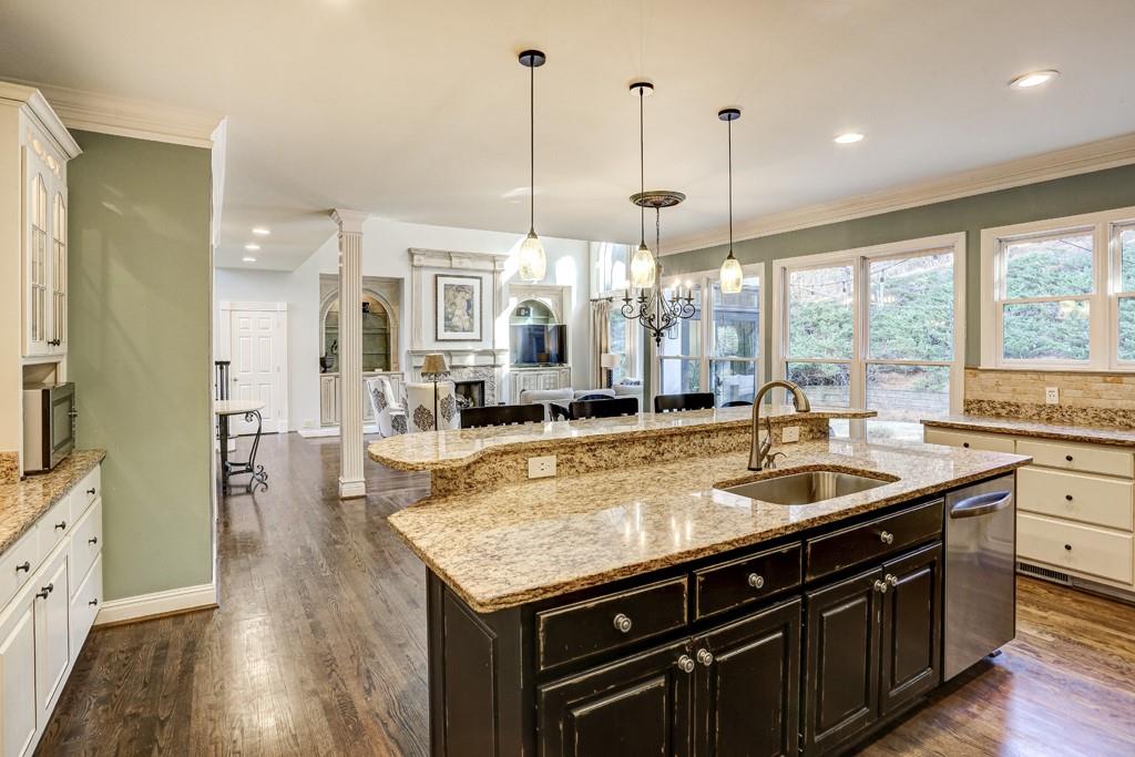 5940 Whitestone Lane Suwanee, GA 30024 - Photo 22 of 63 a kitchen with stainless steel appliances granite countertop a sink a stove and a wooden floors