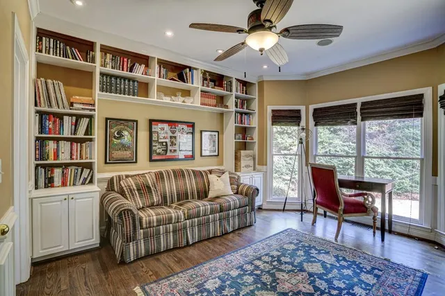 a view of a house with backyard and sitting area