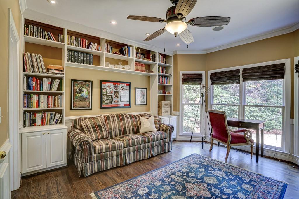 5940 Whitestone Lane Suwanee, GA 30024 - Photo 30 of 63 a living room with furniture and a book shelf