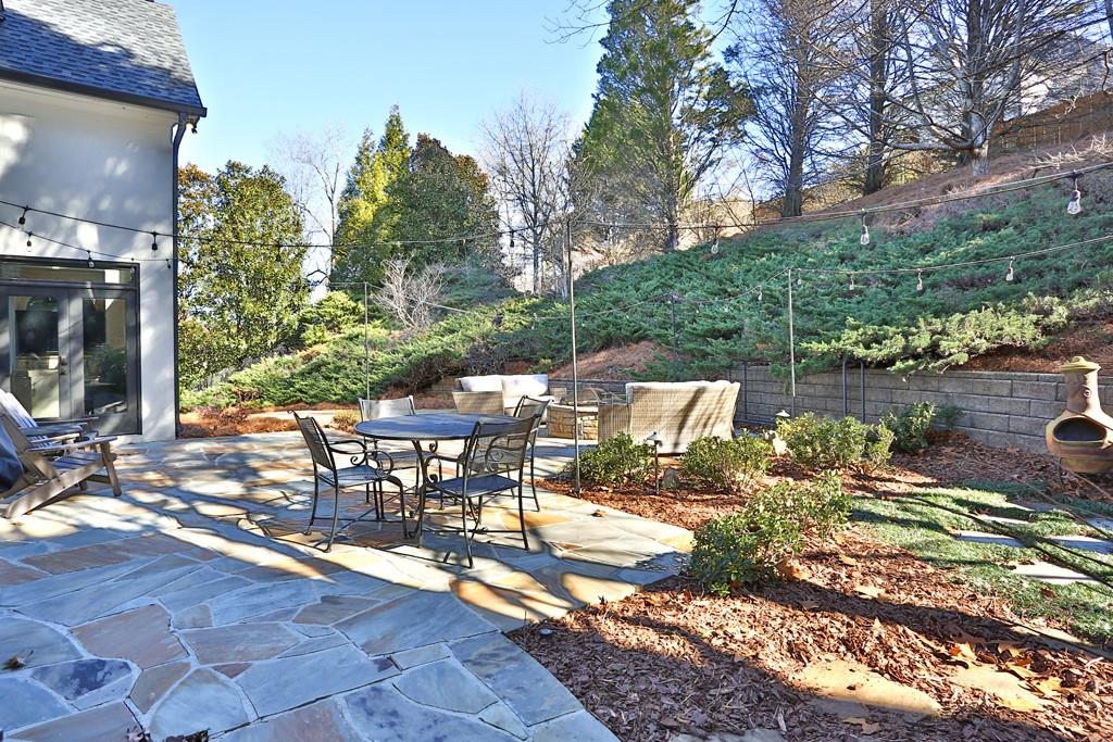 5940 Whitestone Lane Suwanee, GA 30024 - Photo 33 of 63 a view of a patio with table and chairs and potted plants