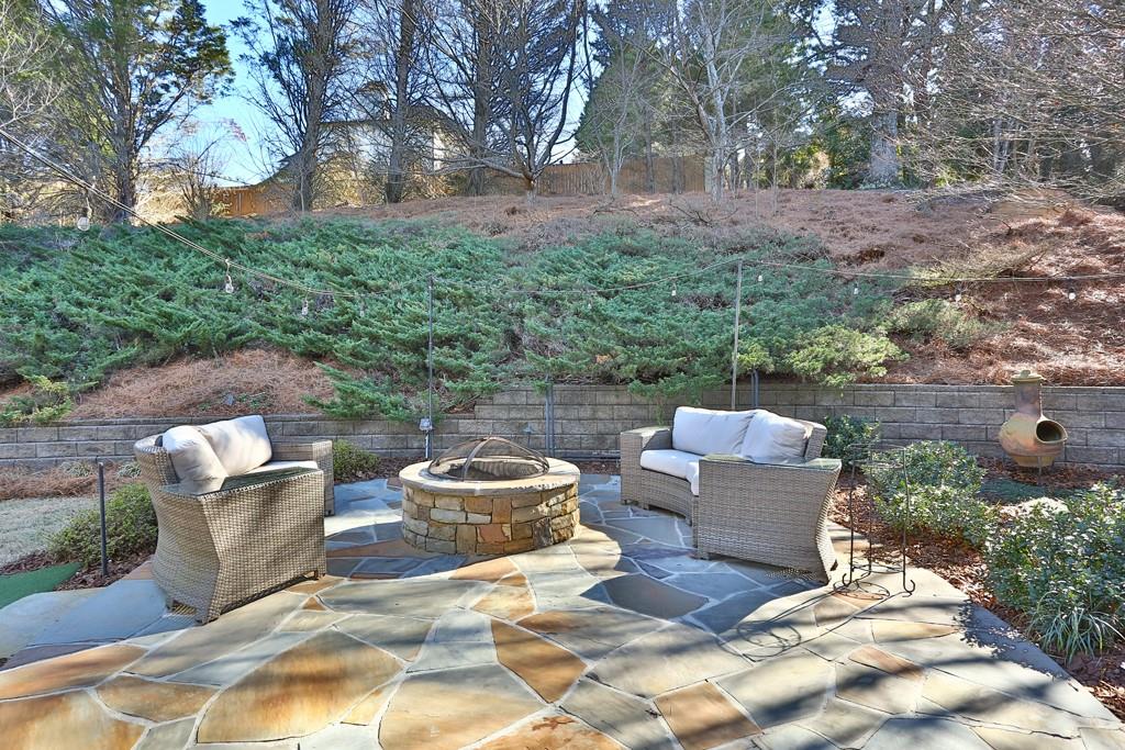 5940 Whitestone Lane Suwanee, GA 30024 - Photo 34 of 63 a view of a patio with couches and a fire pit