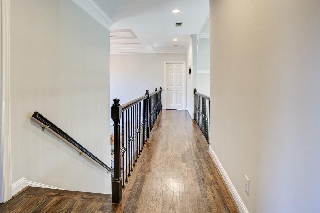 5940 Whitestone Lane Suwanee, GA 30024 - Photo 38 of 63 a view of a hallway with wooden floor and staircase