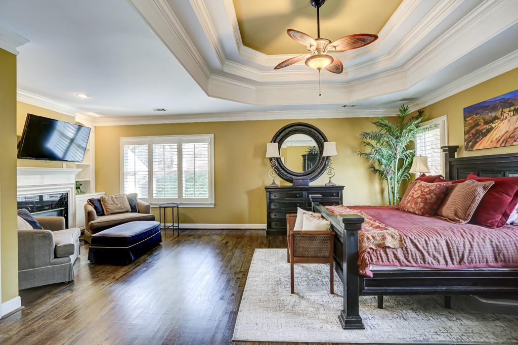 5940 Whitestone Lane Suwanee, GA 30024 - Photo 42 of 63 a living room with furniture a fireplace and a flat screen tv
