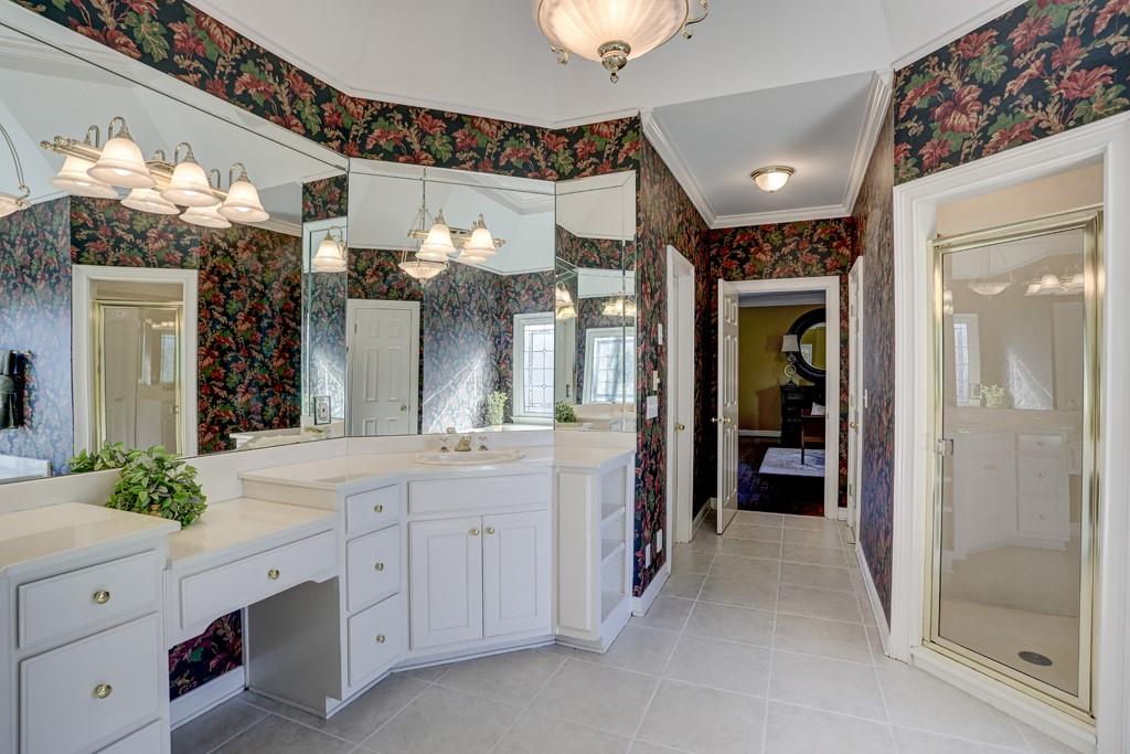 5940 Whitestone Lane Suwanee, GA 30024 - Photo 48 of 63 a bathroom with a double vanity sink and a mirror