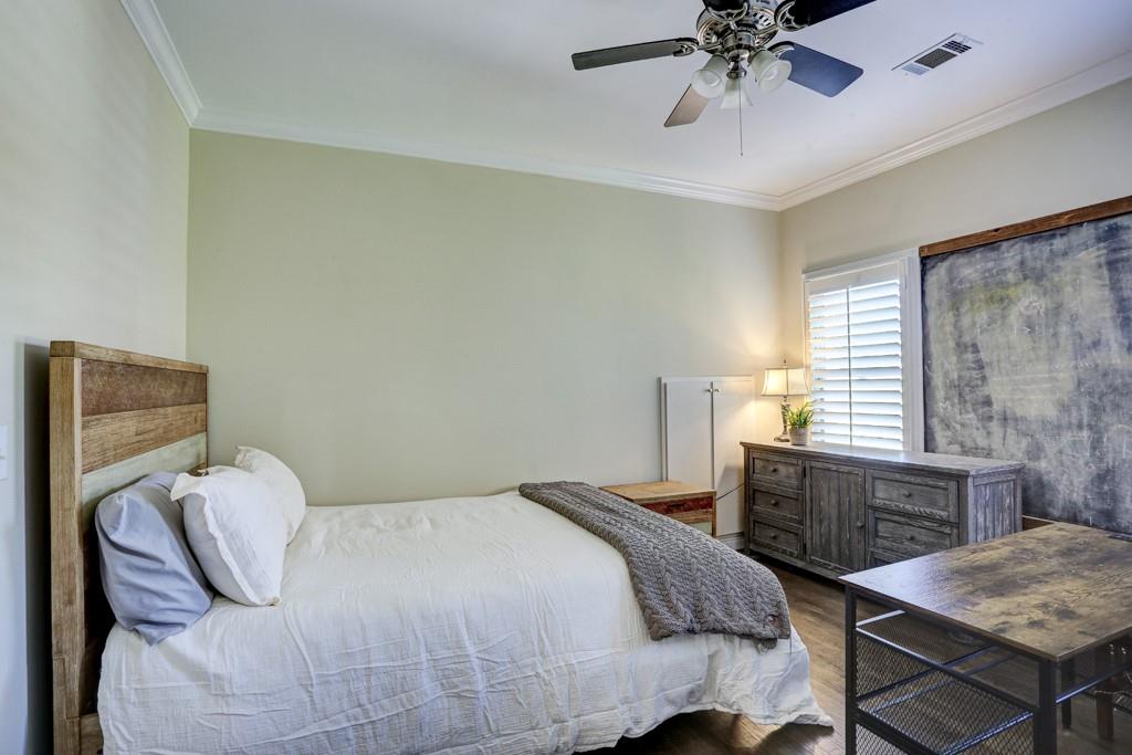 5940 Whitestone Lane Suwanee, GA 30024 - Photo 51 of 63 a bedroom with a bed and a table in it