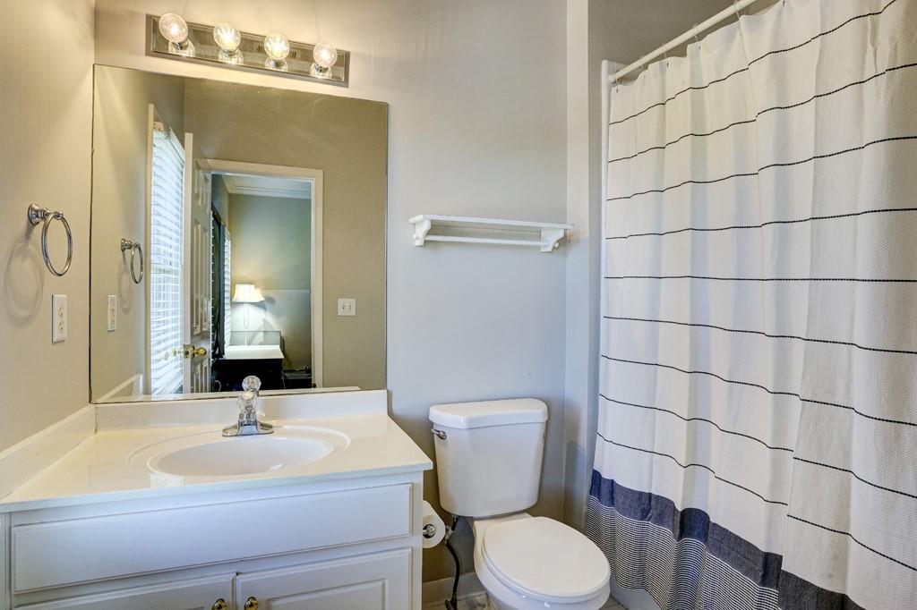 5940 Whitestone Lane Suwanee, GA 30024 - Photo 52 of 63 a bathroom with a sink and a mirror