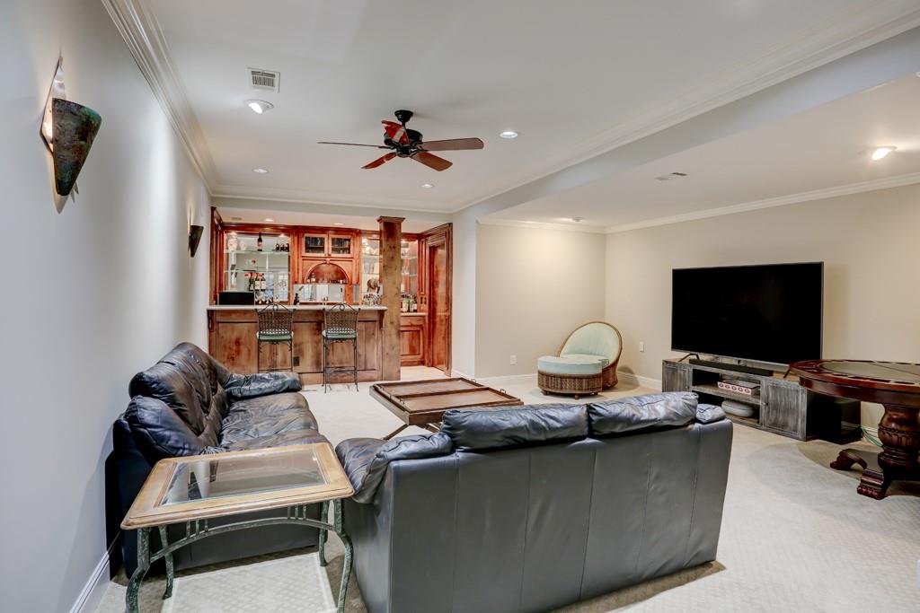 5940 Whitestone Lane Suwanee, GA 30024 - Photo 53 of 63 a living room with furniture and a flat screen tv