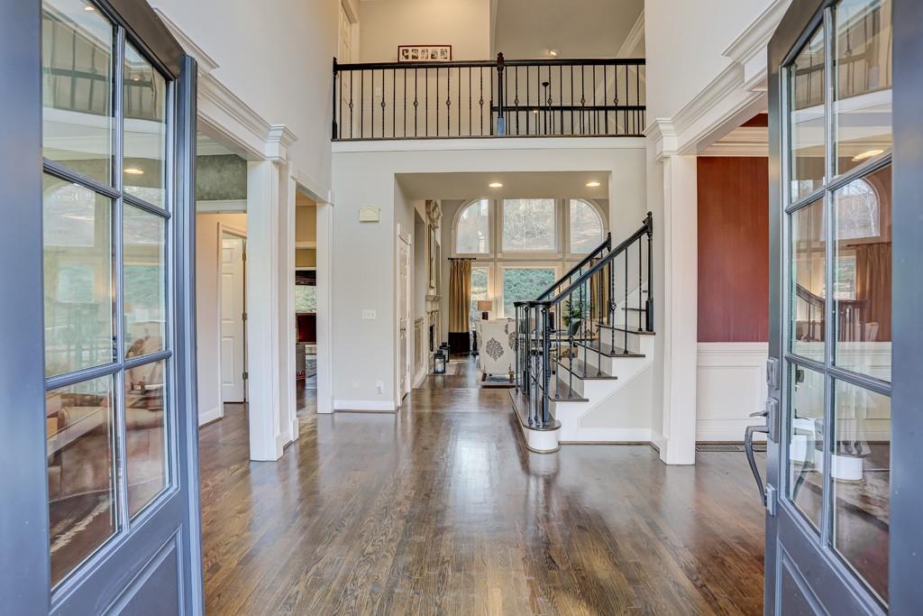 5940 Whitestone Lane Suwanee, GA 30024 - Photo 7 of 63 a view of entryway with wooden floor and stairs
