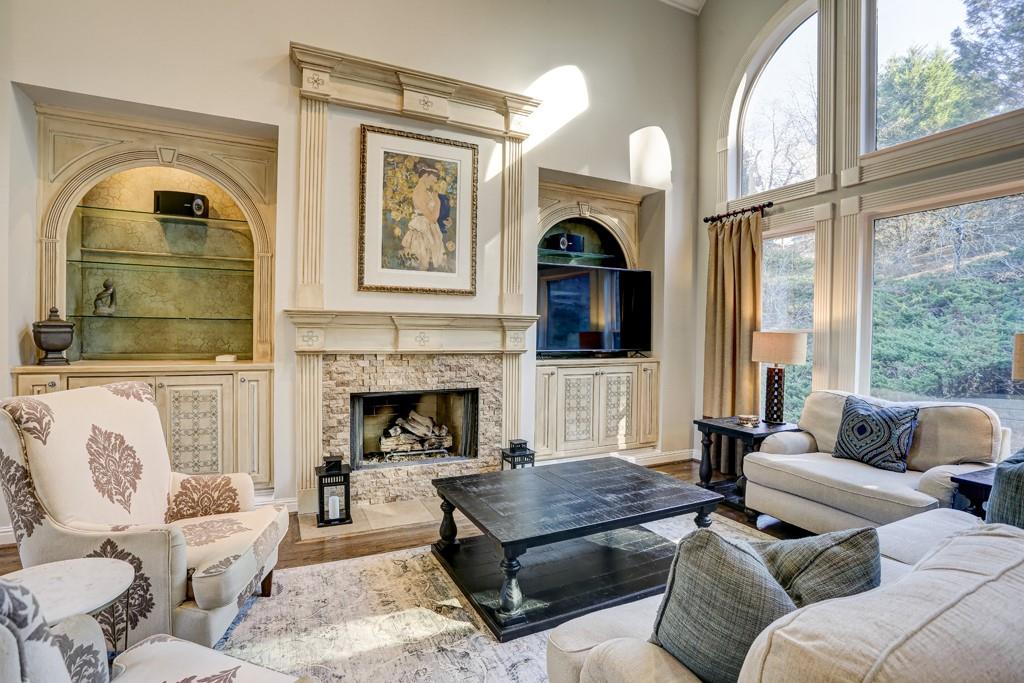 5940 Whitestone Lane Suwanee, GA 30024 - Photo 10 of 63 a living room with furniture fireplace and a large window
