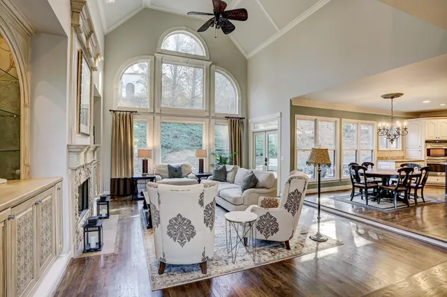 a living room with furniture fireplace and a large window