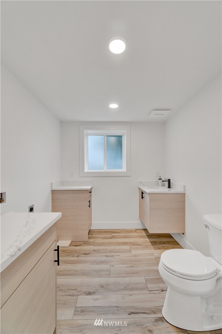 4606 237th Place Southwest Mountlake Terrace, WA 98043 - Photo 25 of 40 a bathroom with a toilet a sink and mirror