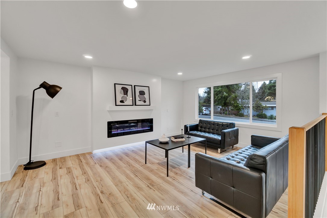 4606 237th Place Southwest Mountlake Terrace, WA 98043 - Photo 8 of 40 a living room with furniture and a fireplace