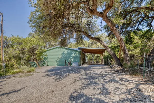 a view of a house with large trees