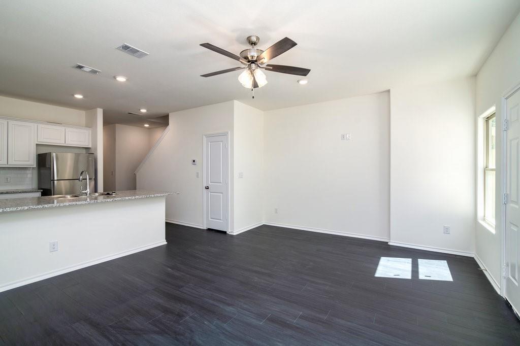 803 South 6th Street Bonham, TX 75418 - Photo 4 of 19 a view of an empty room with wooden floor and a ceiling fan