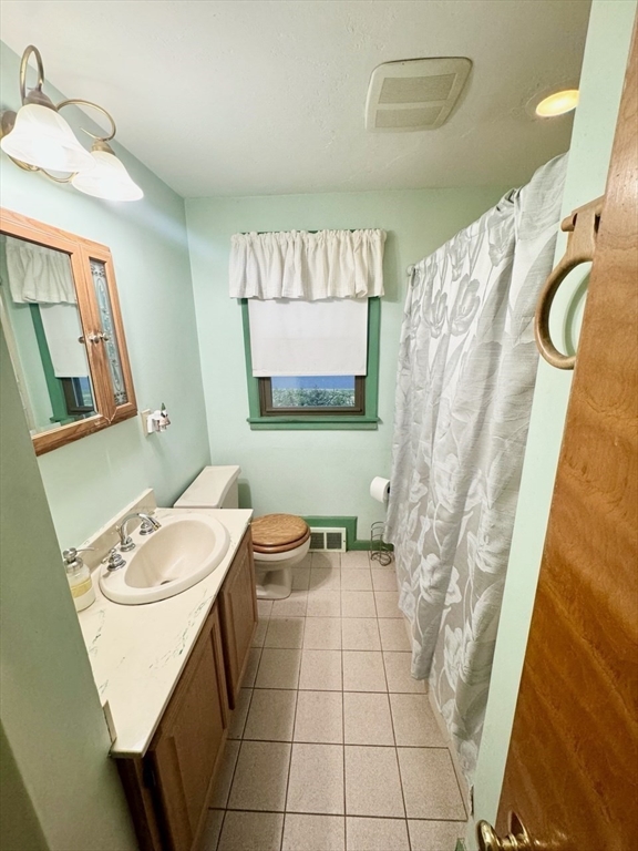 16 Gary Road Springfield, MA 01119 - Photo 17 of 22 a bathroom with a sink a toilet and mirror
