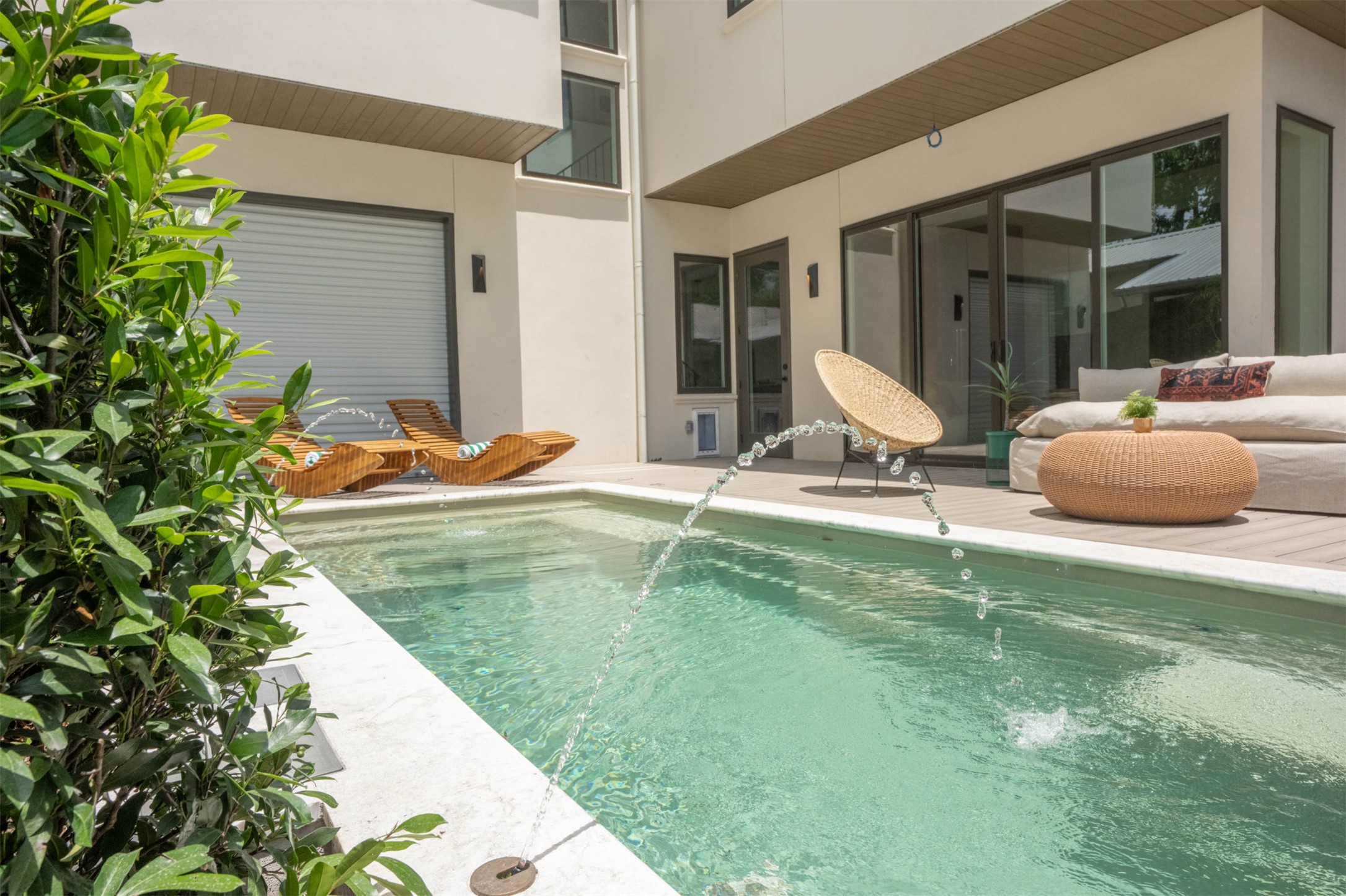 4713 Bolm Road Austin, TX 78702 - Photo 4 of 40 Private swimming pool with integrated water features and white coping, bordered by a composite deck