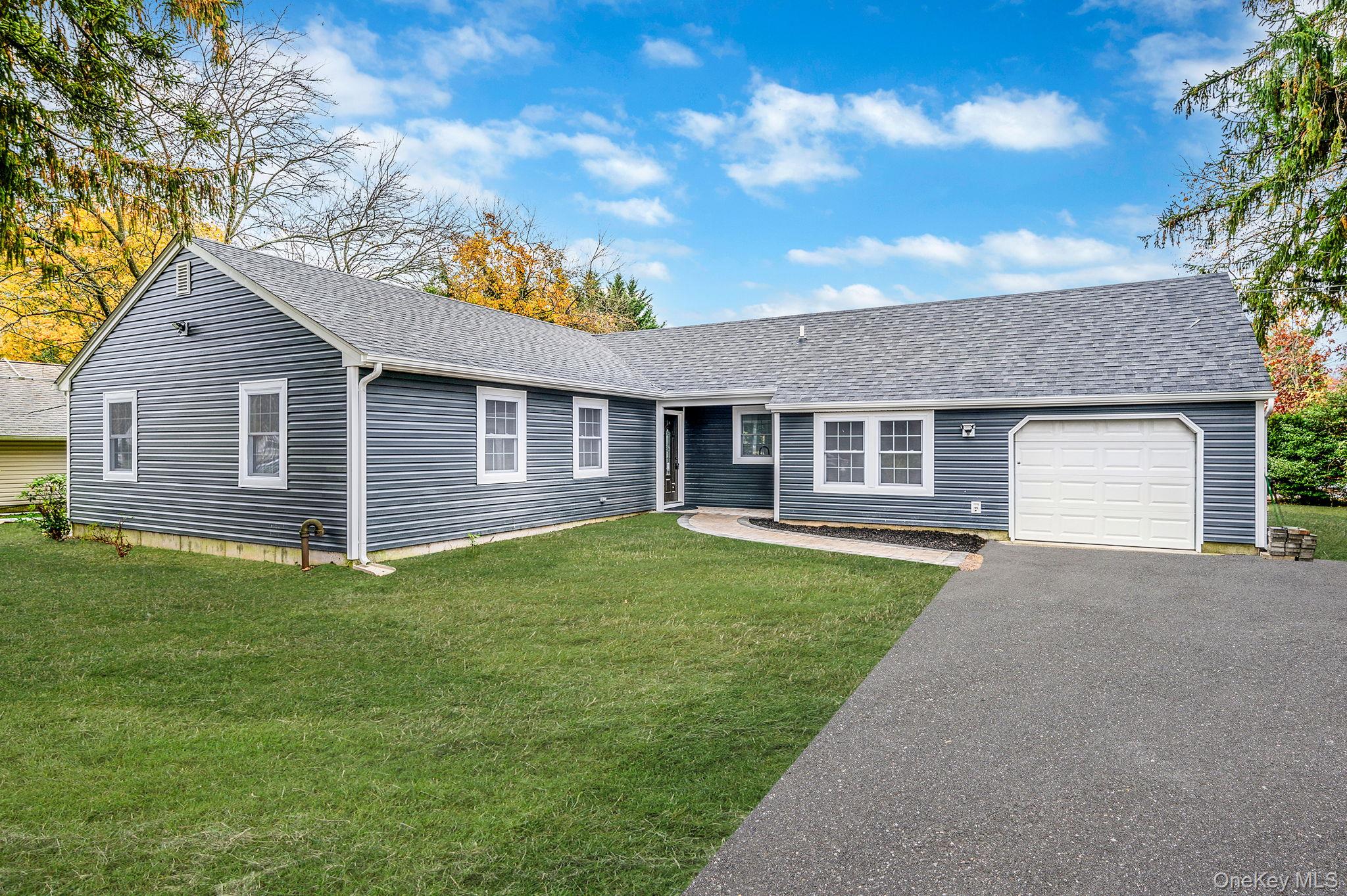 50 7th Street St. James, NY 11780 - Photo 1 of 25 a front view of a house with a garden