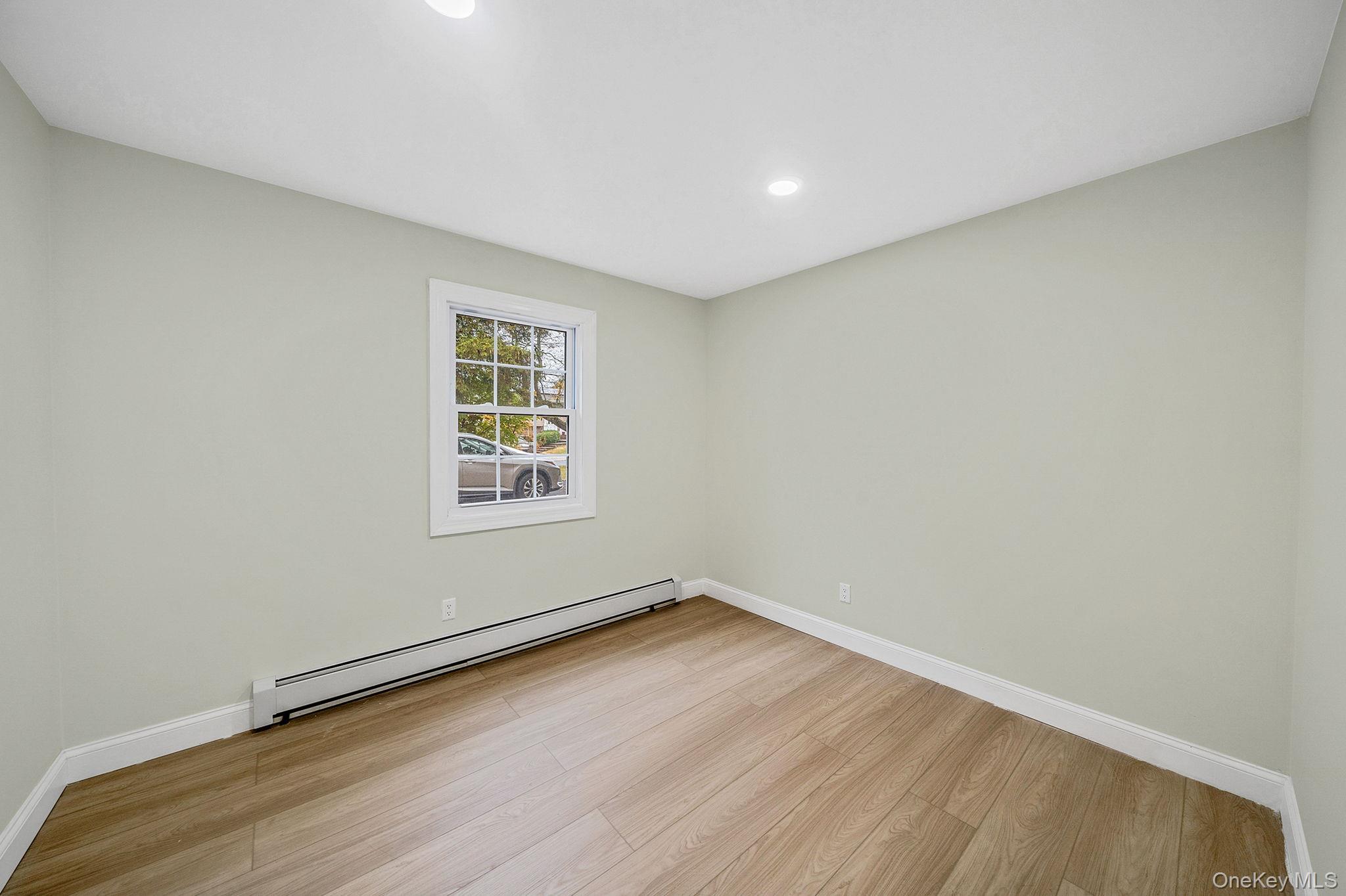 50 7th Street St. James, NY 11780 - Photo 13 of 25 a view of a room with wooden floor and window