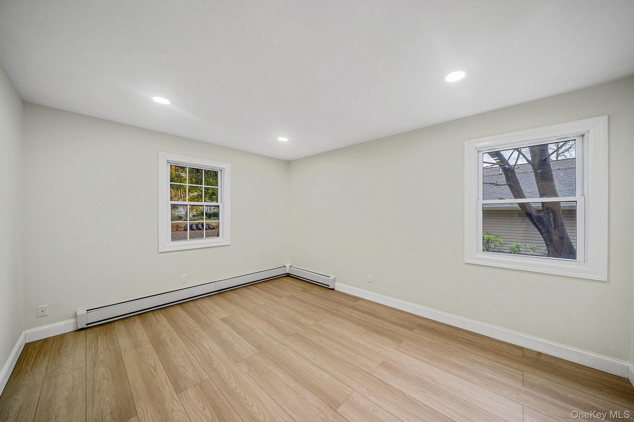 50 7th Street St. James, NY 11780 - Photo 15 of 25 wooden floor in an empty room with a window
