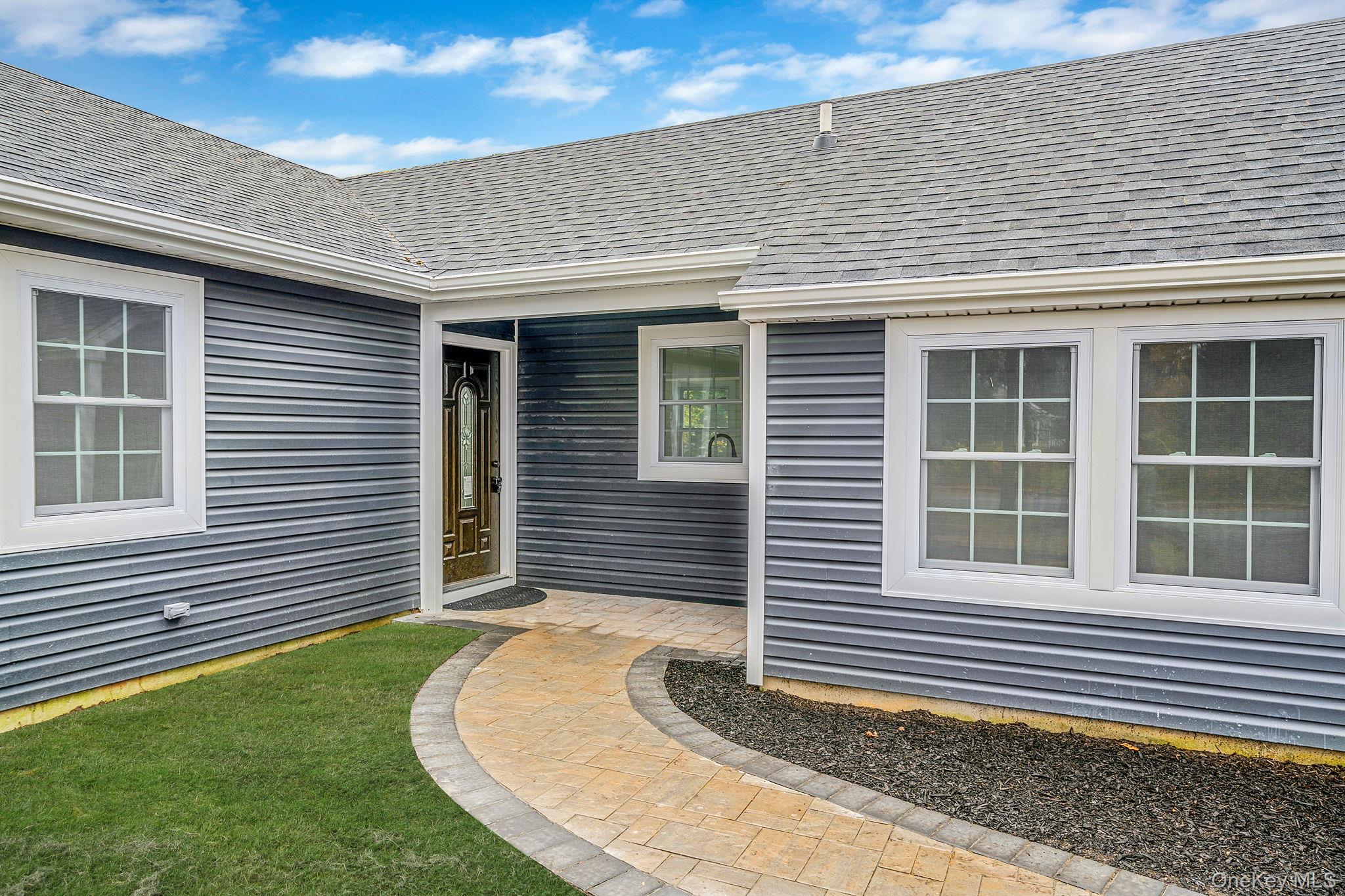 50 7th Street St. James, NY 11780 - Photo 2 of 25 a front view of a house with a garden