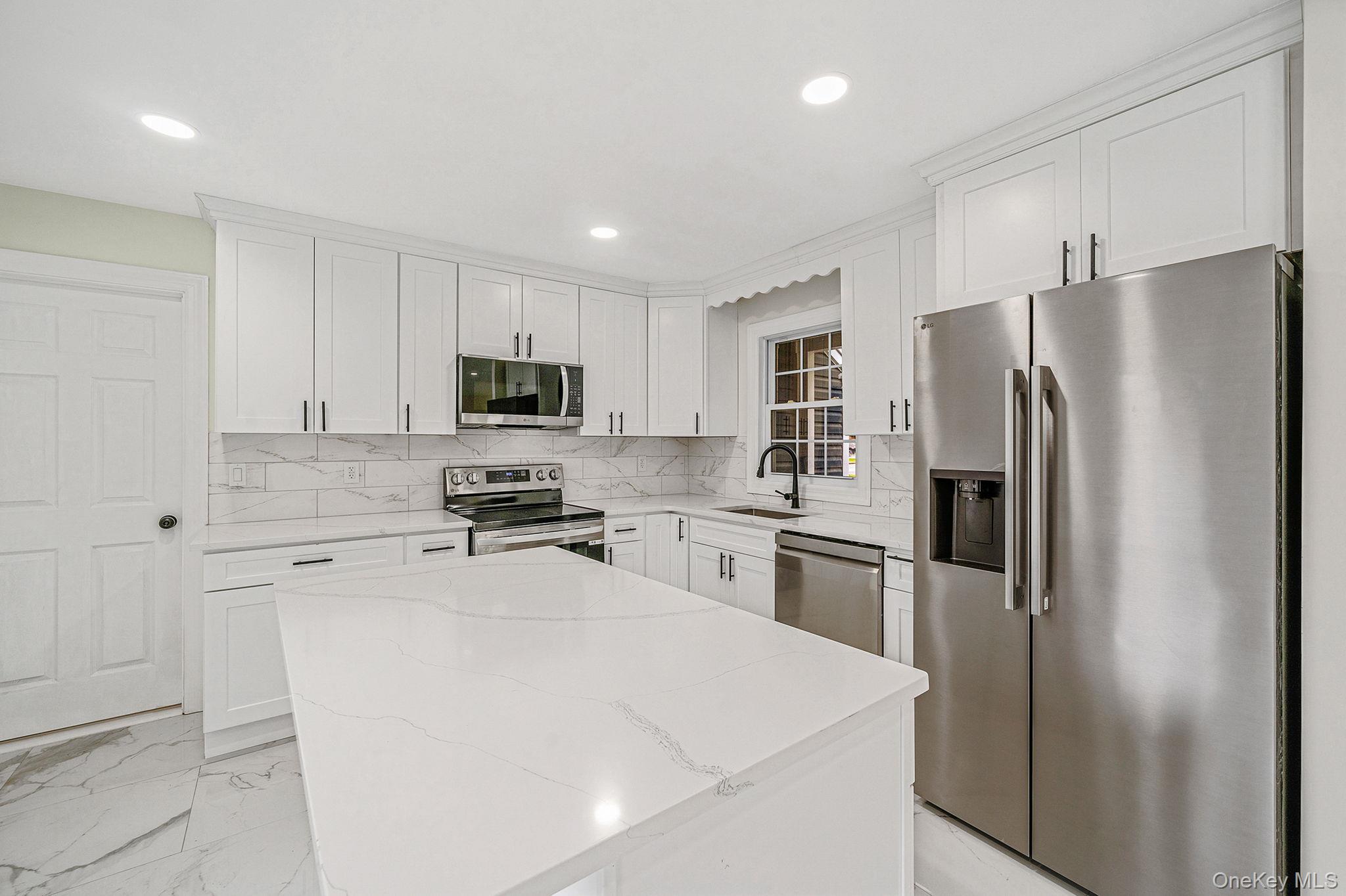 50 7th Street St. James, NY 11780 - Photo 6 of 25 a kitchen with a refrigerator stove and microwave