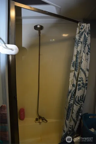 a view of backyard with small deck and a fire pit