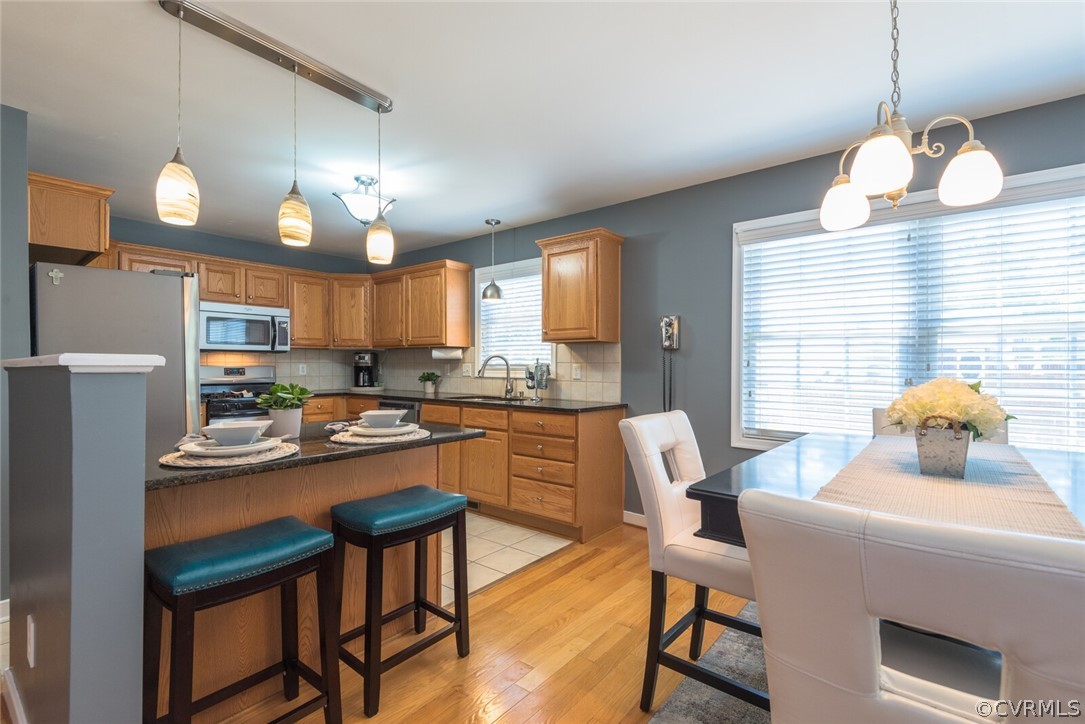 11616 Hillside Road Chester, VA 23831 - Photo 11 of 42 a kitchen with stainless steel appliances granite countertop a sink a stove a refrigerator cabinets and a dining table