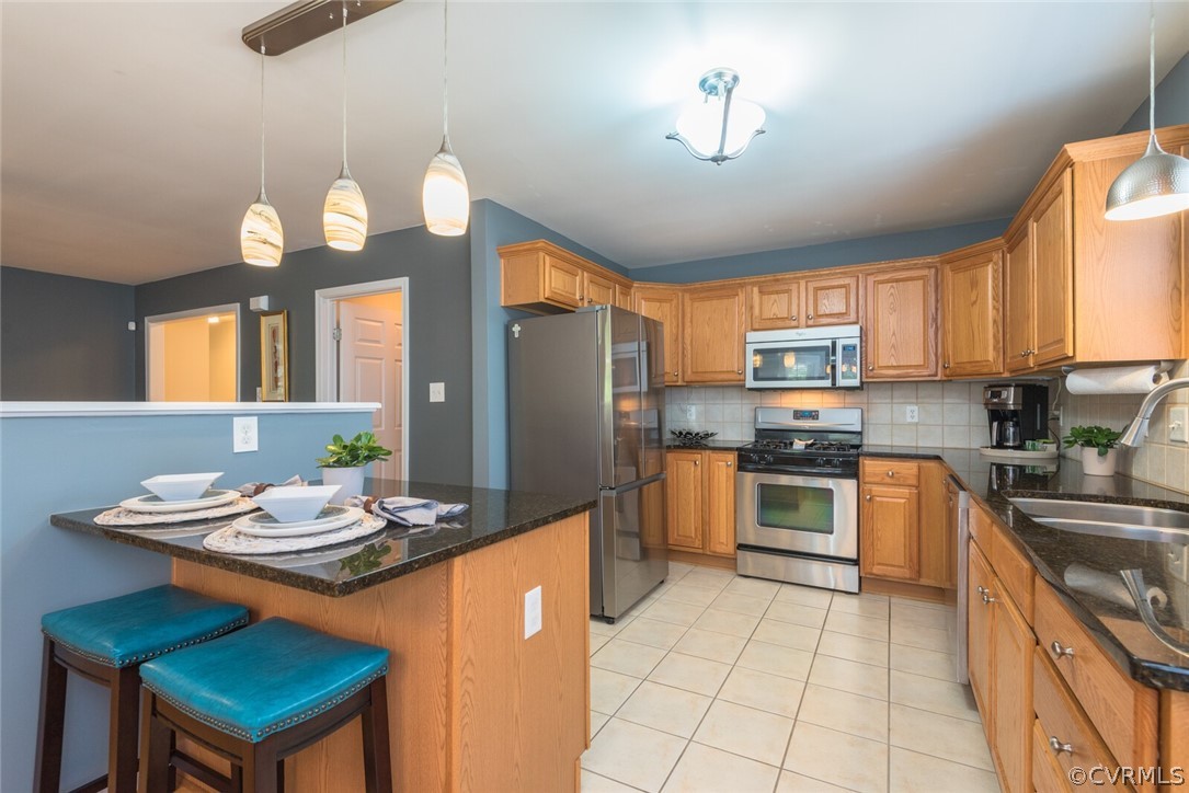 11616 Hillside Road Chester, VA 23831 - Photo 13 of 42 a kitchen with stainless steel appliances granite countertop wooden cabinets a stove top oven a sink and dishwasher