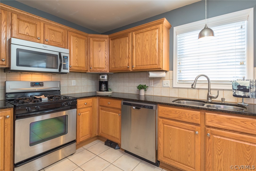 11616 Hillside Road Chester, VA 23831 - Photo 16 of 42 a kitchen with stainless steel appliances granite countertop white cabinets a stove a sink and a microwave