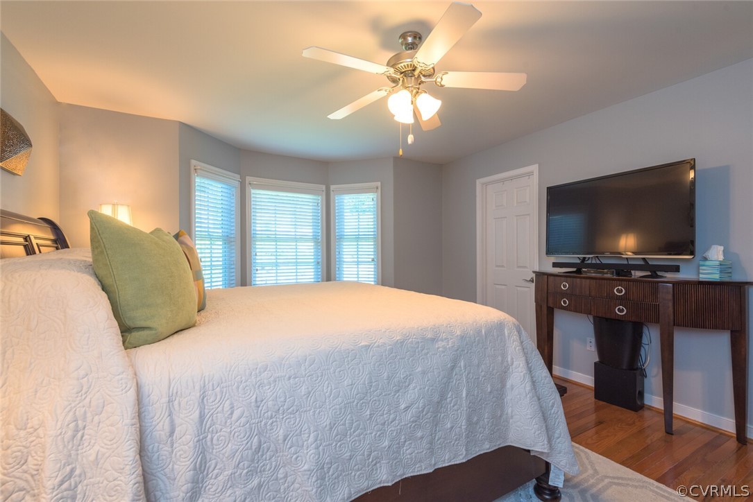 11616 Hillside Road Chester, VA 23831 - Photo 17 of 42 a bedroom with a large bed and a flat screen tv