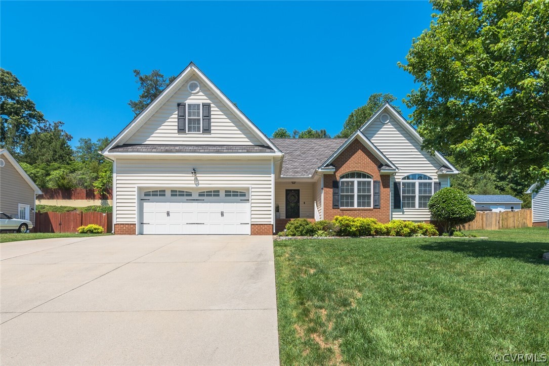 11616 Hillside Road Chester, VA 23831 - Photo 2 of 42 a front view of a house with a yard and garage