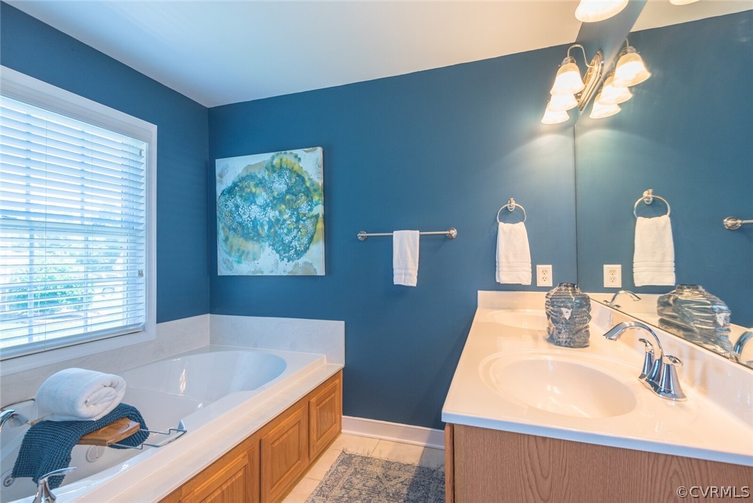 11616 Hillside Road Chester, VA 23831 - Photo 22 of 42 a bathroom with a tub sink and mirror